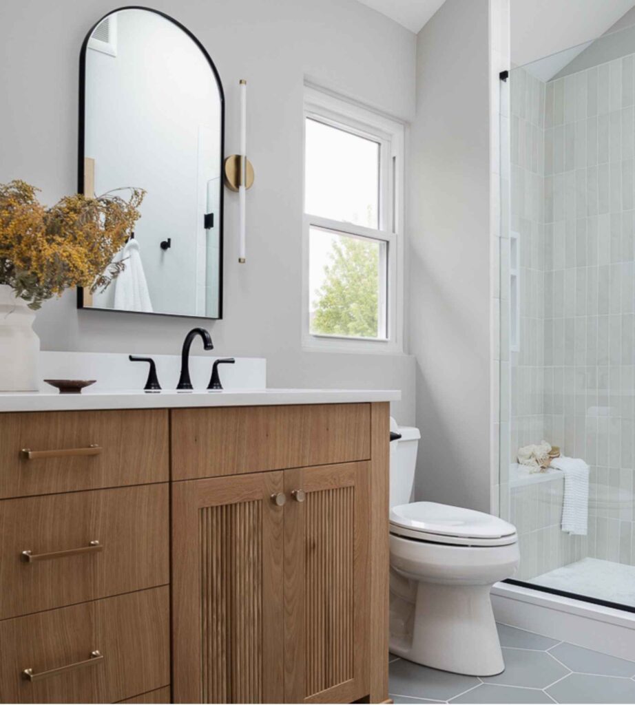 full-service-interior-design-north-woods-wi-discovering-your-personal-design-style-bathroom-remodel-with-soft-colors-wood-vanity-arched-mirror-collected