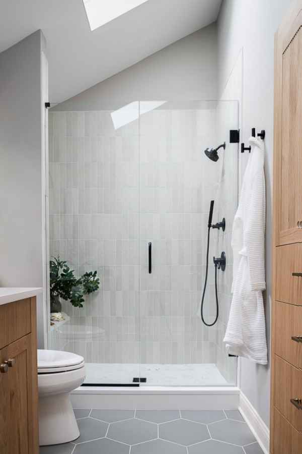 full-service-interior-design-60091-design-challenges-and-solutions-renovated-bathroom-light-and-bright-gray-tile-floor-skylight-meaningful-bathroom-remodel