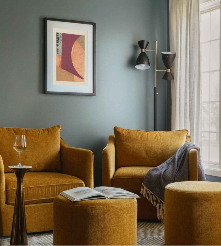full-service-interior-design-60614-curating-a-meaningful-art-collection-sitting-area-with-mustard-chairs-deep-teal-walls-custom-artwork-personal-home-renovation