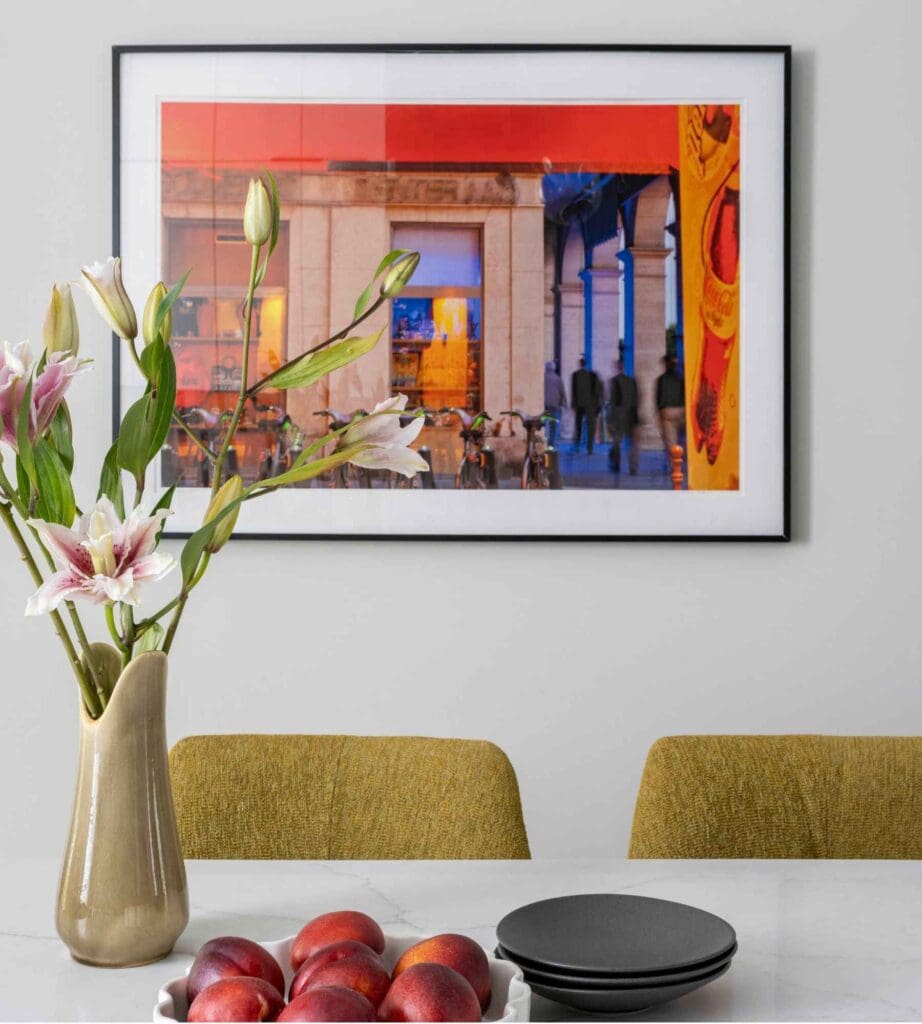 kp-home-lake-view-il-curating-a-meaningful-art-collection-bright-colorful-painting-in-neutral-kitchen-quartzite-countertop-pop-of-color-edgy-interior-design