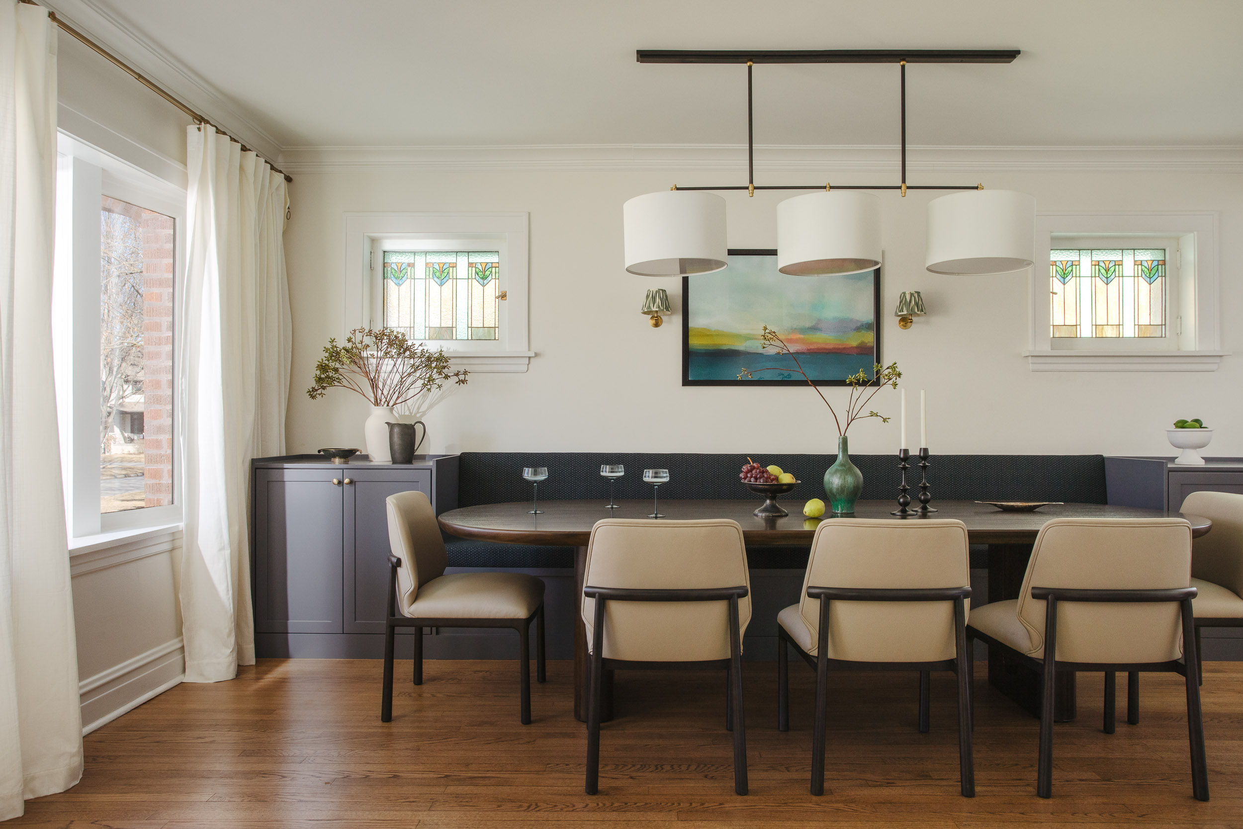 kp-home-60091-slow-decorating-contemporary-dining-room-built-in-banquette-oval-table-stained-glass-windows-thoughtful-interior-design