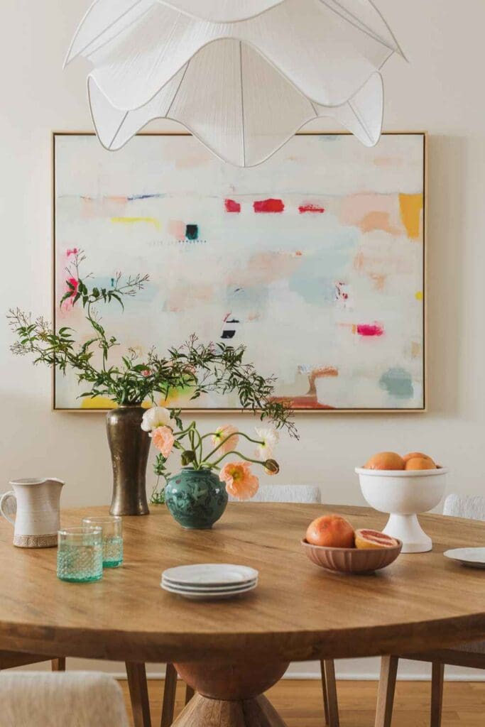full-service-interior-design-chicago-il-logan-square-home-tour-round-dining-table-soft-white-curved-light-fixture-pastel-abstract-art-sustainability