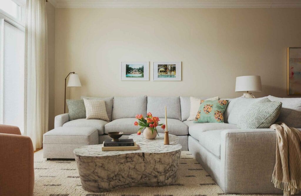 kp-home-lake-view-il-logan-square-home-tour-living-room-soft-colors-large-sectional-throws-and-pillows-stone-coffee-table-texture-thoughtful